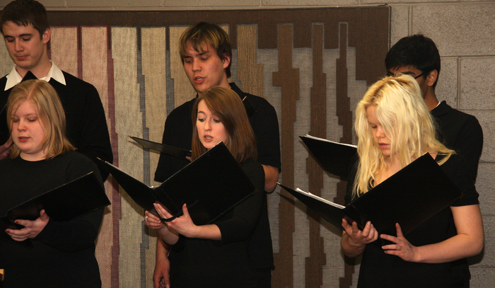 Six students singing in a choir.