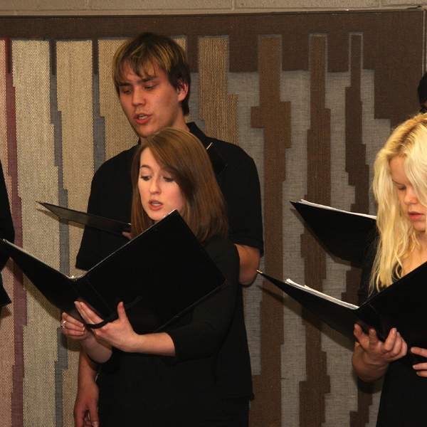 Six students singing in a choir.