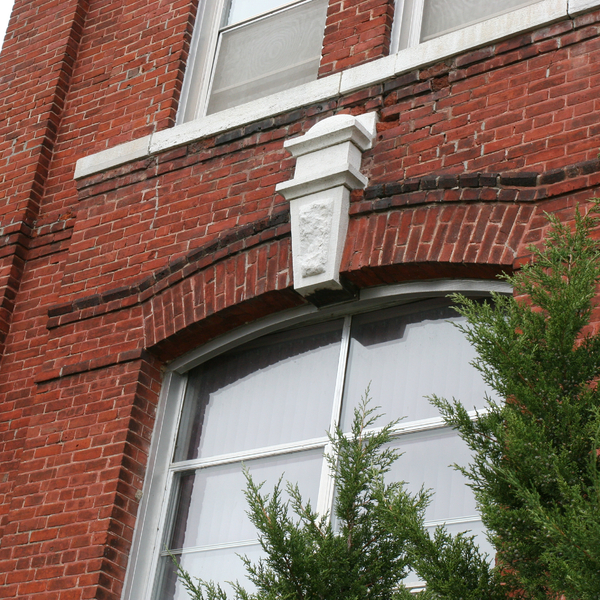 Window with Cornice on Red Brick Building